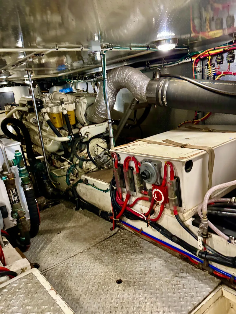 Slide: The Image of Engine room of 1997 McKinna 48 Pilothouse yacht, showcasing mechanical components and wiring. - 48
