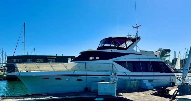 Slide: The Image of 1997 McKinna 48 Pilothouse yacht docked at marina under clear blue sky. - 6