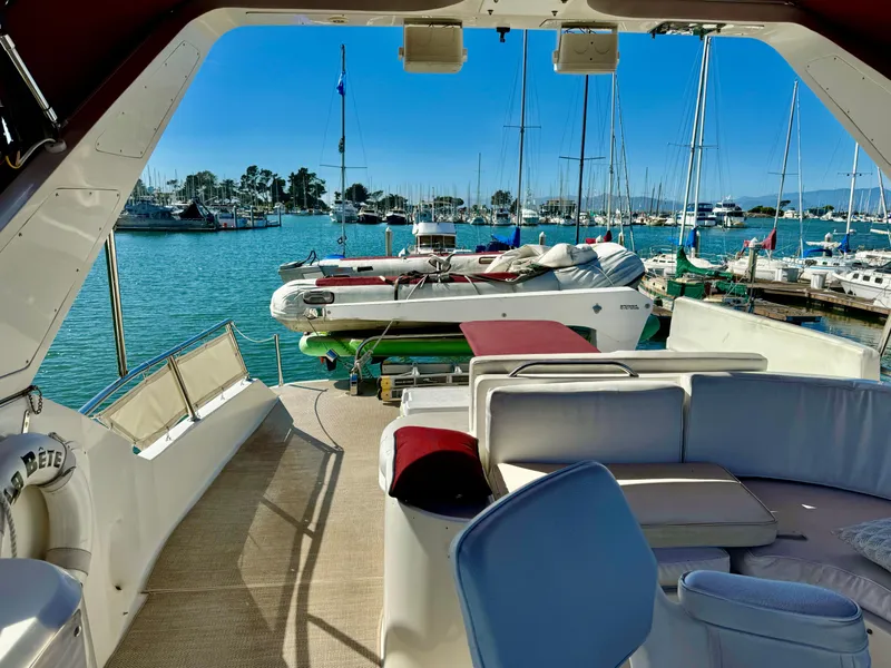 Slide: The Image of 1997 McKinna 48 Pilothouse yacht interior with marina view and seating area. - 8