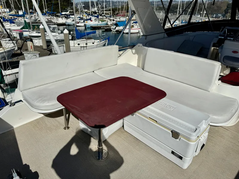 Slide: The Image of Outdoor seating area on a 1997 McKinna 48 Pilothouse yacht with marina view. - 9
