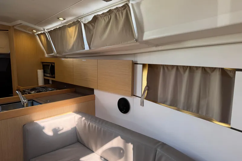 Slide: The Image of Interior of 2018 Beneteau Oceanis 35.1 yacht with modern kitchen and seating area. - 12