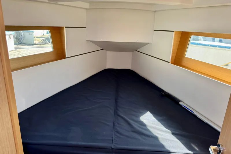 Slide: The Image of 2018 Beneteau Oceanis 35.1 cabin interior with windows and black mattress. - 18