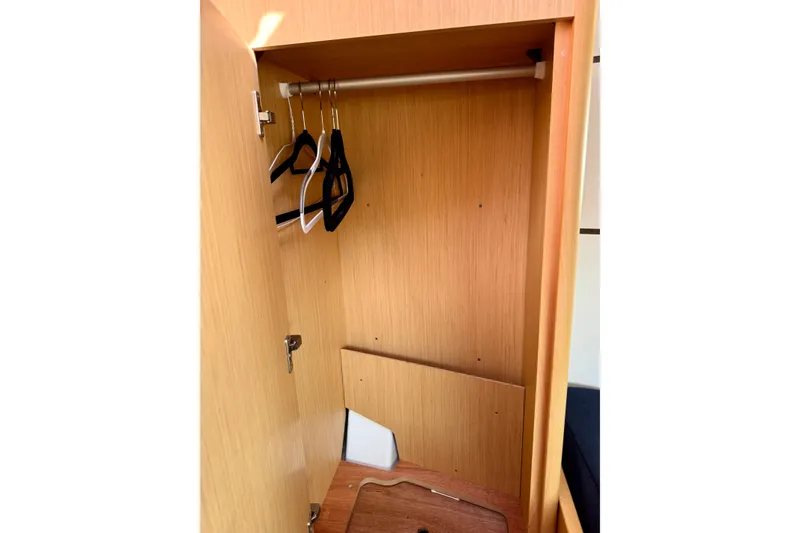 Slide: The Image of Wooden closet interior with hangers in a 2018 Beneteau Oceanis 35.1 yacht. - 19