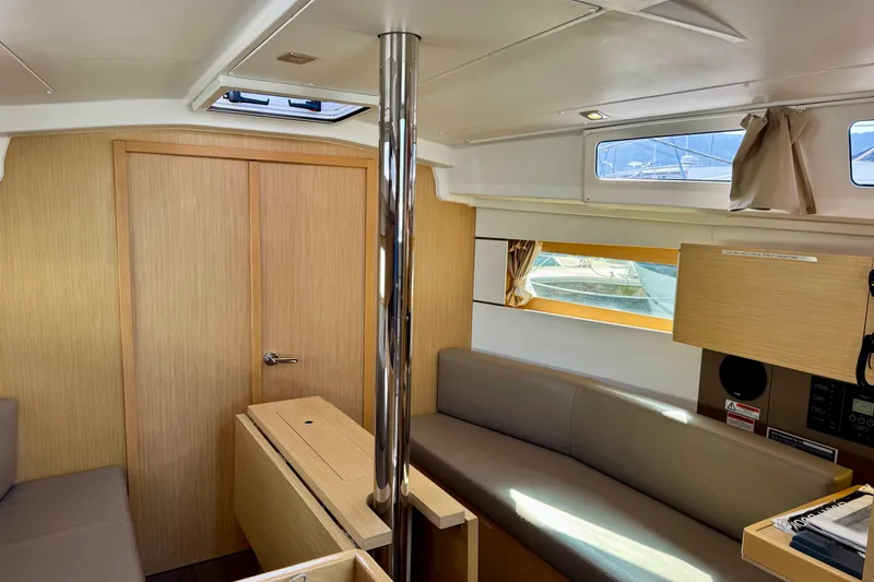 Slide: The Image of Interior of 2018 Beneteau Oceanis 35.1 sailboat, featuring modern wood finish and seating area. - 20
