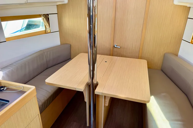 Slide: The Image of Interior of 2018 Beneteau Oceanis 35.1 yacht with wooden dining table and seating. - 23