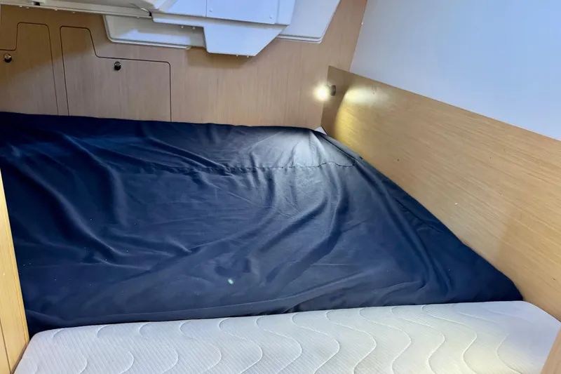 Slide: The Image of Cozy cabin interior of 2018 Beneteau Oceanis 35.1 sailboat with blue bedding. - 26