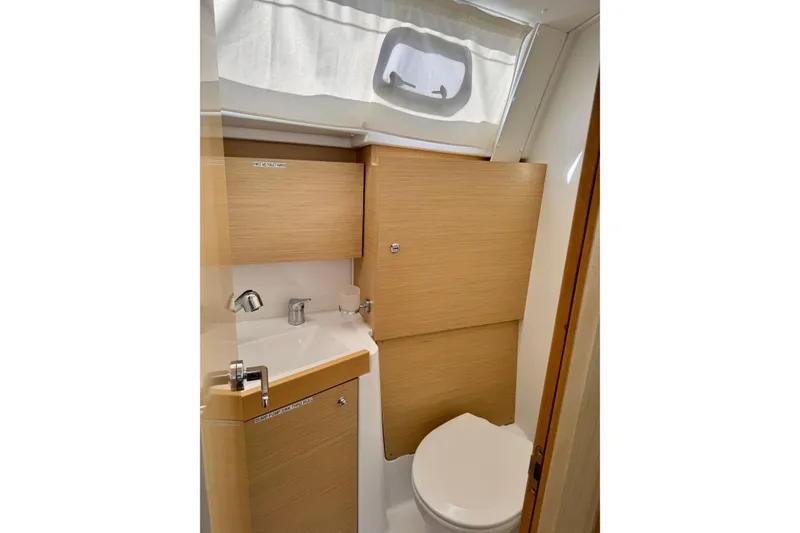Slide: The Image of 2018 Beneteau Oceanis 35.1 bathroom with modern fixtures and wooden cabinetry. - 28