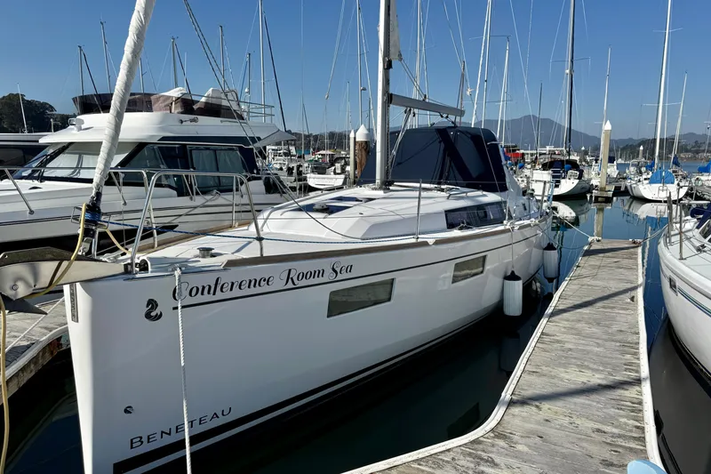 Slide: The Image of 2018 Beneteau Oceanis 35.1 sailboat docked in marina, named "Conference Room Sea". - 3