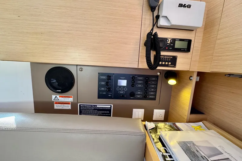 Slide: The Image of 2018 Beneteau Oceanis 35.1 yacht interior control panel with navigation equipment. - 32