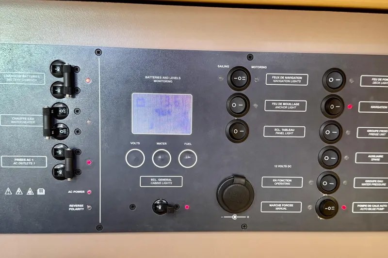 Slide: The Image of Control panel of a 2018 Beneteau Oceanis 35.1 sailboat, featuring various switches and indicators. - 33