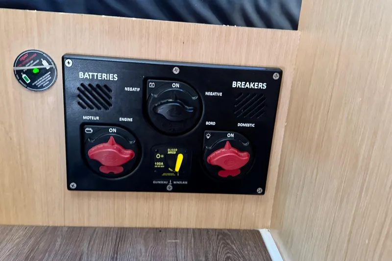 Slide: The Image of Control panel of a 2018 Beneteau Oceanis 35.1 yacht, featuring battery and breaker switches. - 37