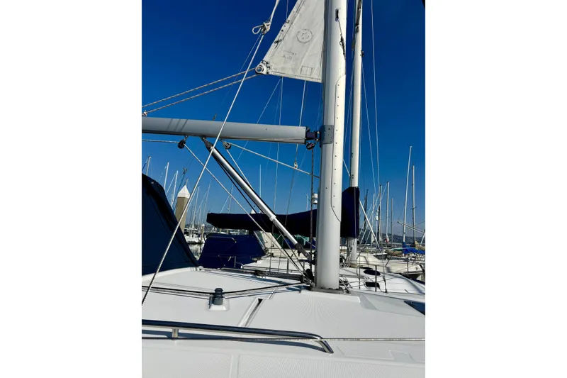 Slide: The Image of 2018 Beneteau Oceanis 35.1 sailboat mast and deck in marina under clear blue sky. - 4
