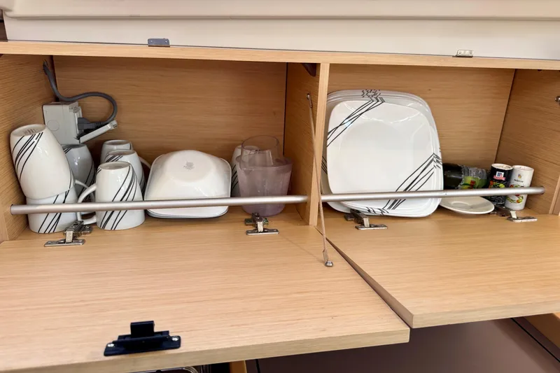 Slide: The Image of Cabinet with dishes and cups inside a 2018 Beneteau Oceanis 35.1 yacht. - 44