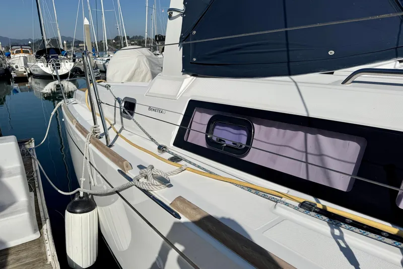 Slide: The Image of 2018 Beneteau Oceanis 35.1 yacht docked at marina, side view with ropes and fender. - 5