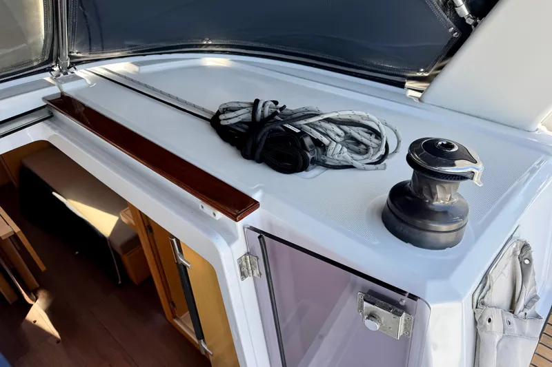 Slide: The Image of 2018 Beneteau Oceanis 35.1 yacht deck with winch and coiled rope. - 55