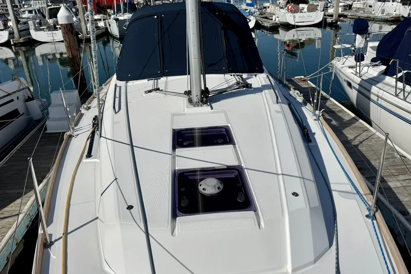 Slide: The Image of 2018 Beneteau Oceanis 35.1 sailboat docked in a marina, showcasing sleek deck design. - 59