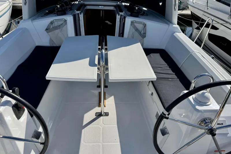 Slide: The Image of 2018 Beneteau Oceanis 35.1 yacht cockpit with dual steering wheels and foldable table. - 6