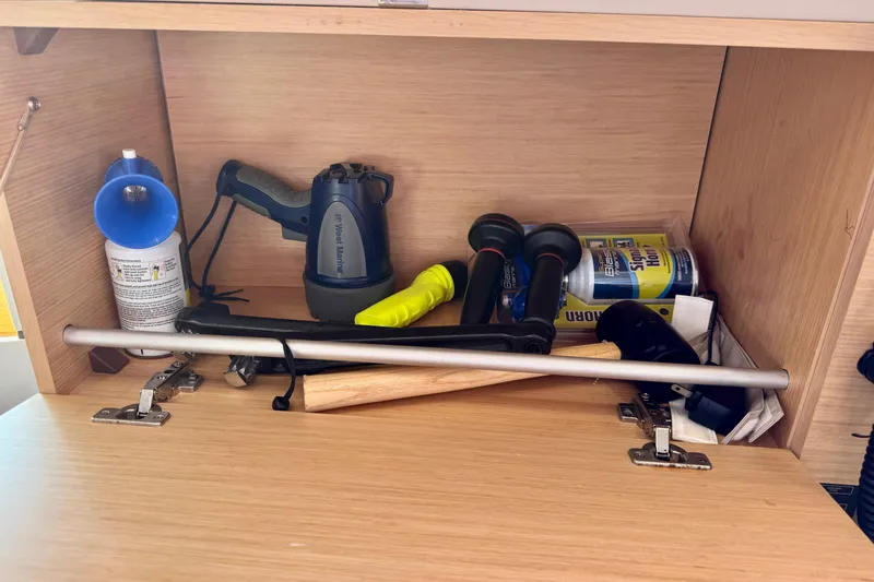 Slide: The Image of Storage compartment on a 2018 Beneteau Oceanis 35.1 yacht with various tools and supplies. - 61