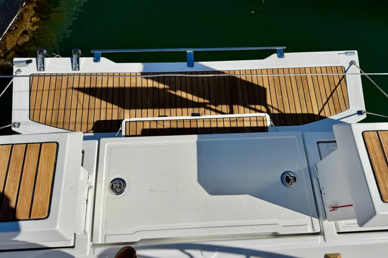 Slide: The Image of Beneteau Oceanis 35.1 2018 yacht deck with teak flooring and storage compartments. - 68