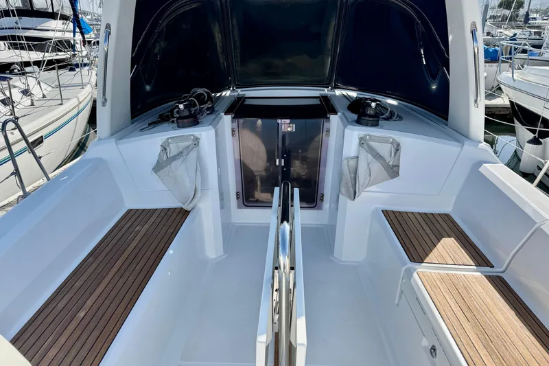 Slide: The Image of 2018 Beneteau Oceanis 35.1 yacht cockpit with teak seating and dual steering wheels. - 7