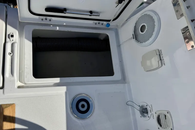 Slide: The Image of Cockpit view of a 2018 Beneteau Oceanis 35.1 sailboat, featuring storage and manual bilge pump. - 70