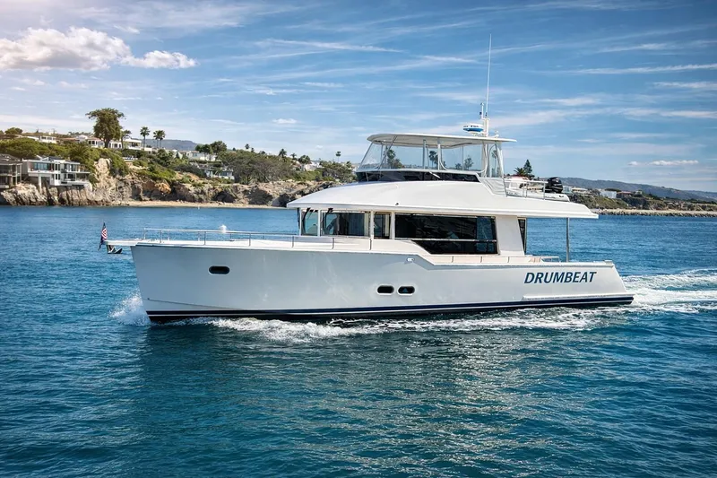 The Image of 2021 Outback Yachts 50 cruising on blue waters near a scenic coastline. - 0