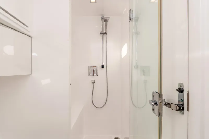 Slide: The Image of Modern shower in 2021 Outback Yachts 50, featuring sleek fixtures and glass door. - 12