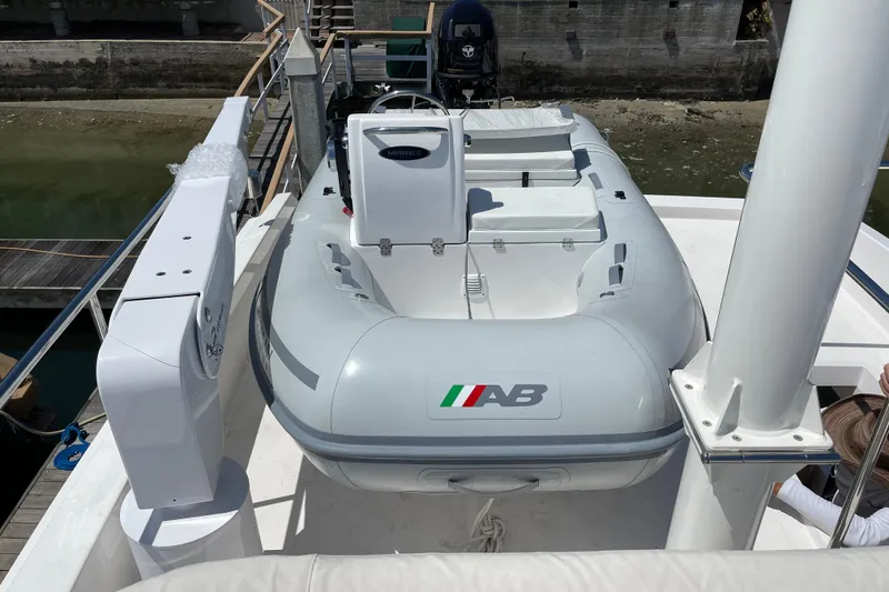 Slide: The Image of Inflatable boat on 2021 Outback Yachts 50 deck, docked at marina. - 18