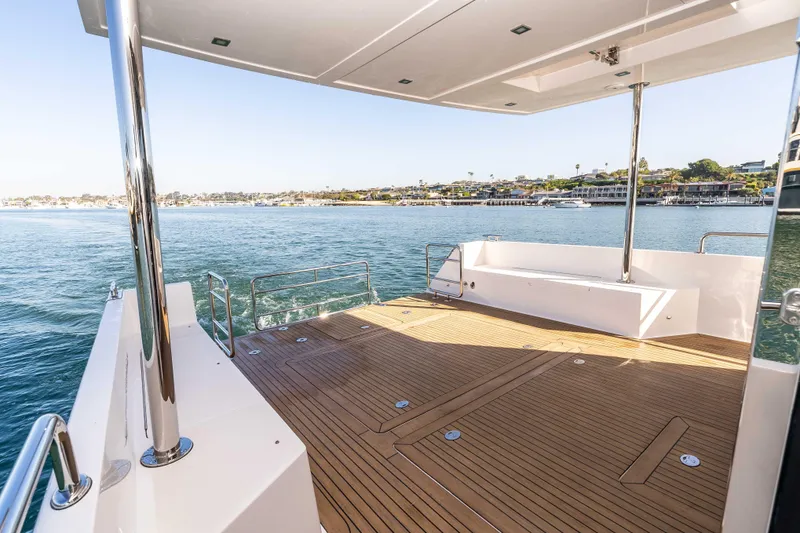 Slide: The Image of Spacious deck of 2021 Outback Yachts 50 overlooking serene waterfront. - 19