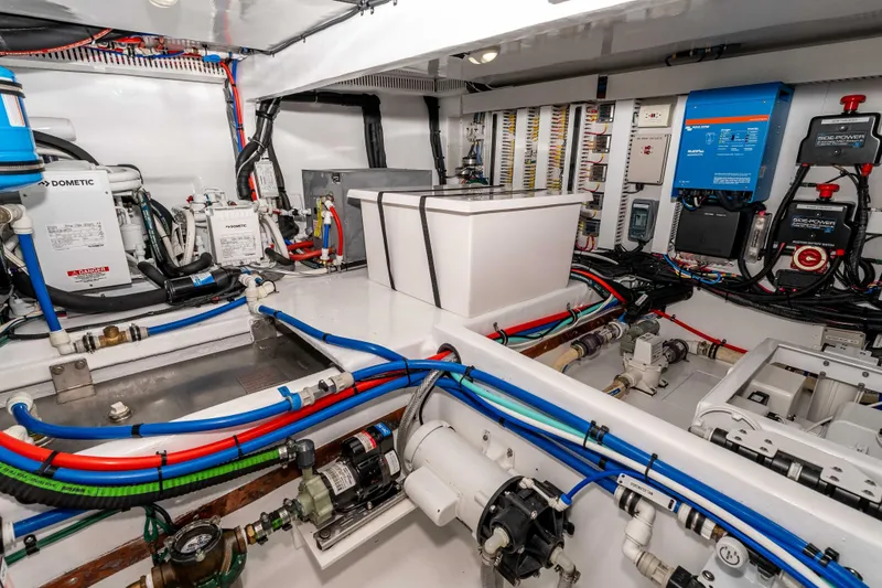 Slide: The Image of Engine room of 2021 Outback Yachts 50, showcasing advanced marine equipment and wiring. - 25