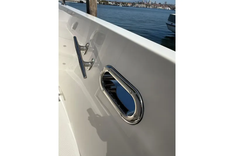 Slide: The Image of Side view of 2021 Outback Yachts 50, featuring sleek design and chrome details. - 27