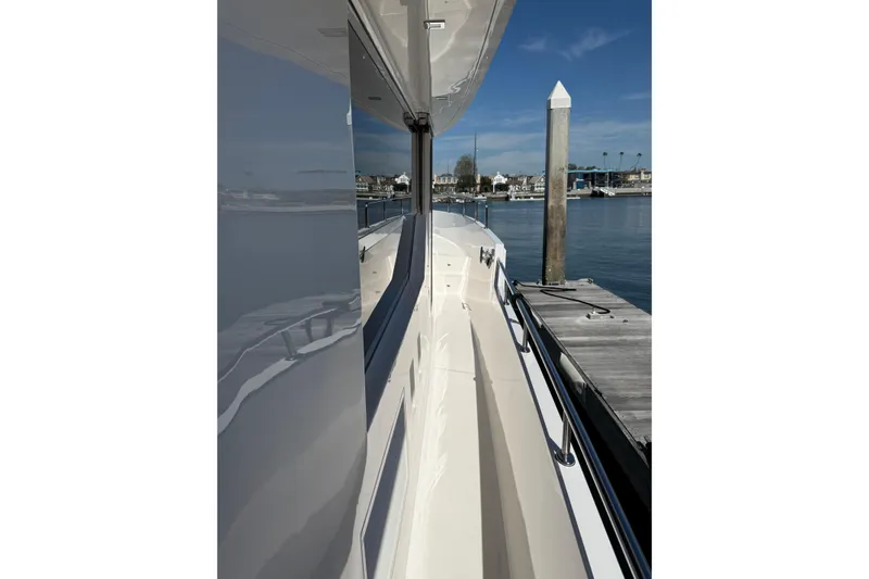 Slide: The Image of 2021 Outback Yachts 50 docked, showcasing sleek design and waterfront view. - 28