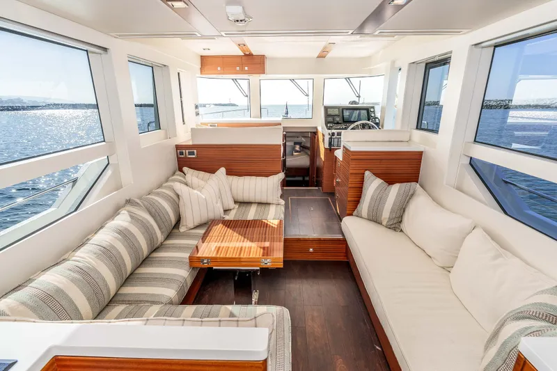Slide: The Image of Luxurious interior of 2021 Outback Yachts 50 with elegant seating and panoramic windows. - 3
