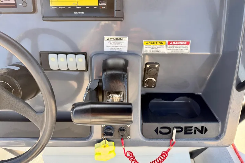 Slide: The Image of Control panel of 2019 Zodiac Open 5.5 boat with Yamaha throttle and safety warnings. - 12