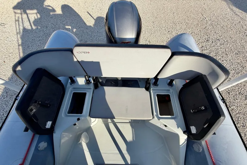 Slide: The Image of 2019 Zodiac Open 5.5 boat interior with storage compartments and seating. - 14