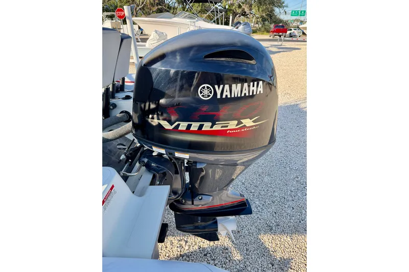 Slide: The Image of Yamaha VMAX outboard motor on 2019 Zodiac Open 5.5 boat, parked on gravel. - 21