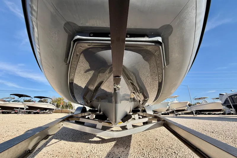 Slide: The Image of 2019 Zodiac Open 5.5 boat on trailer, viewed from below, in a sunny outdoor setting. - 24