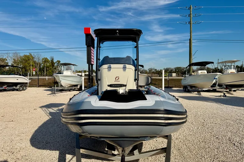 Slide: The Image of 2019 Zodiac Open 5.5 boat displayed outdoors on gravel lot. - 3