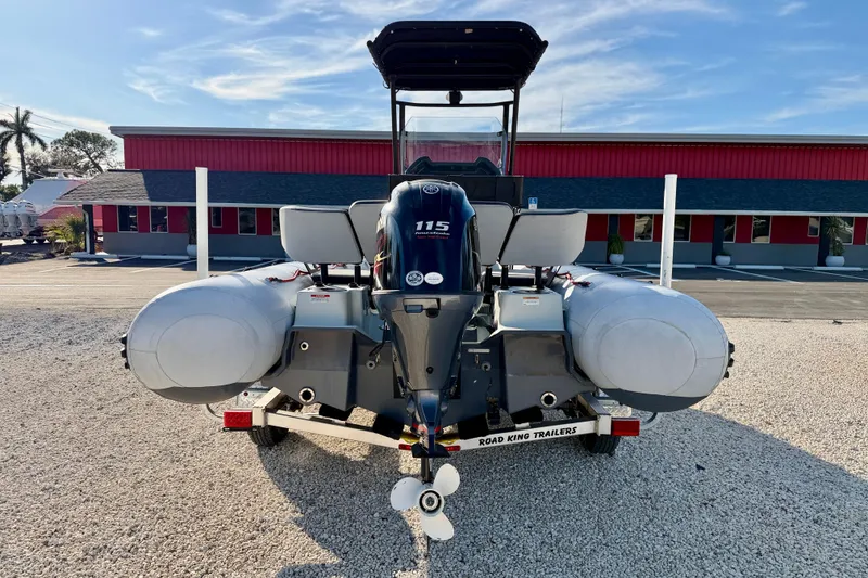 Slide: The Image of 2019 Zodiac Open 5.5 boat on trailer, rear view, parked outdoors. - 6