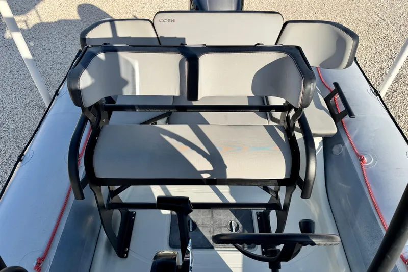 Slide: The Image of 2019 Zodiac Open 5.5 boat interior with seating and steering wheel. - 8
