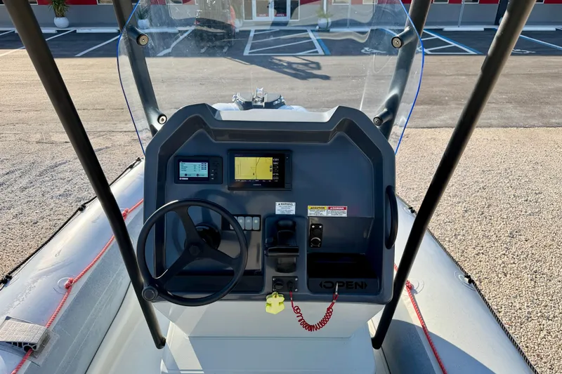 Slide: The Image of 2019 Zodiac Open 5.5 boat dashboard with steering wheel and navigation displays. - 9