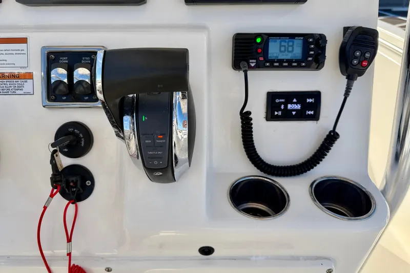 Slide: The Image of 2021 Cobia 237 Center Console boat dashboard with controls and radio system. - 13