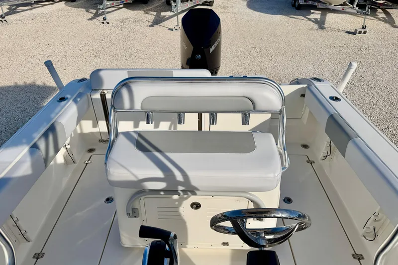 Slide: The Image of 2021 Cobia 237 Center Console boat interior with seating and steering wheel. - 17