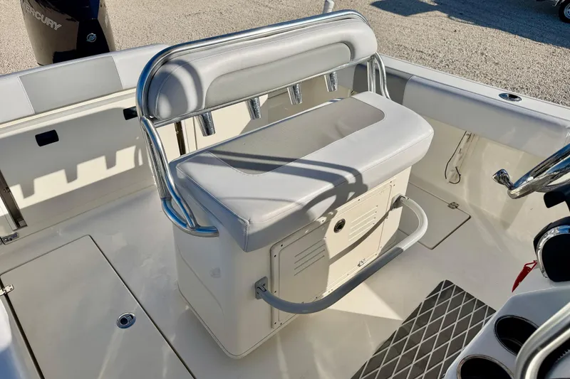 Slide: The Image of 2021 Cobia 237 Center Console boat interior with cushioned seating and storage. - 18