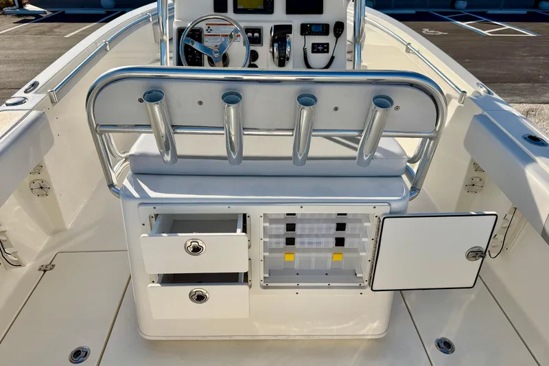 Slide: The Image of 2021 Cobia 237 Center Console boat interior with storage compartments and rod holders. - 19