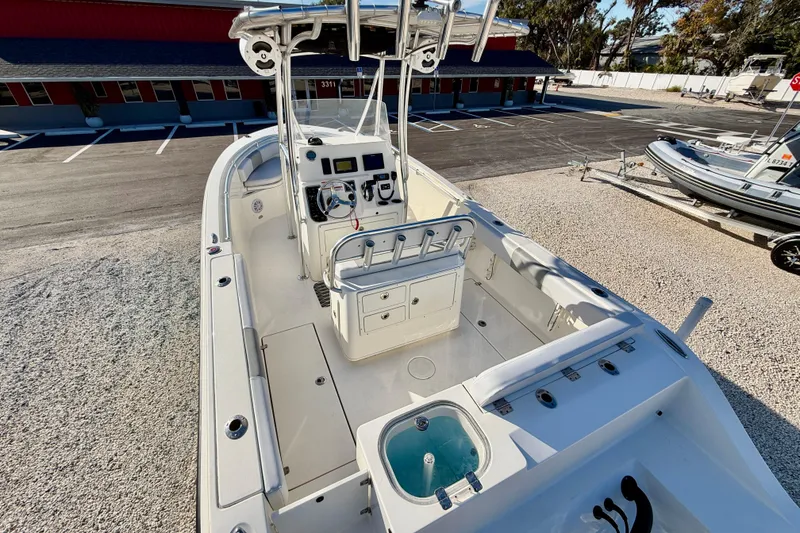 Slide: The Image of 2021 Cobia 237 Center Console boat with spacious deck and modern controls. - 21
