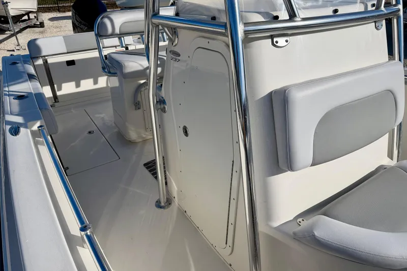 Slide: The Image of 2021 Cobia 237 Center Console boat interior with seating and stainless steel railings. - 24