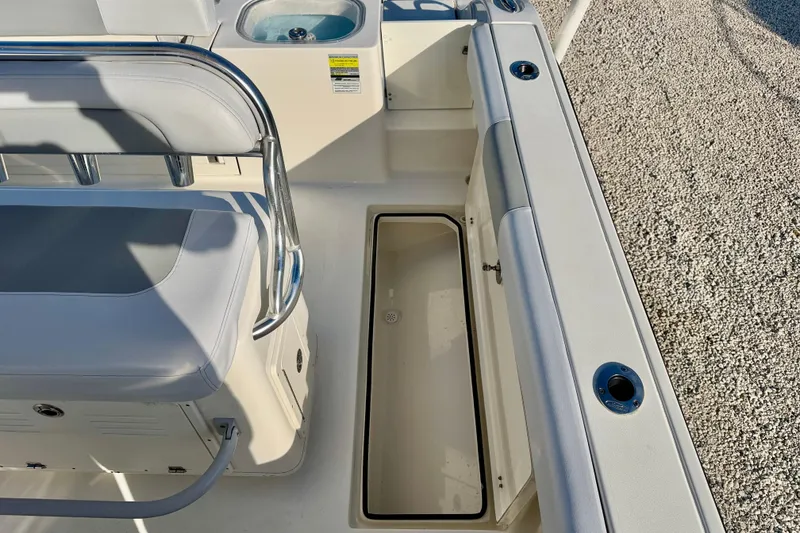 Slide: The Image of 2021 Cobia 237 Center Console boat interior with seating and storage compartments. - 27