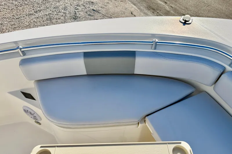 Slide: The Image of 2021 Cobia 237 Center Console boat interior with cushioned seating and stainless steel railing. - 31