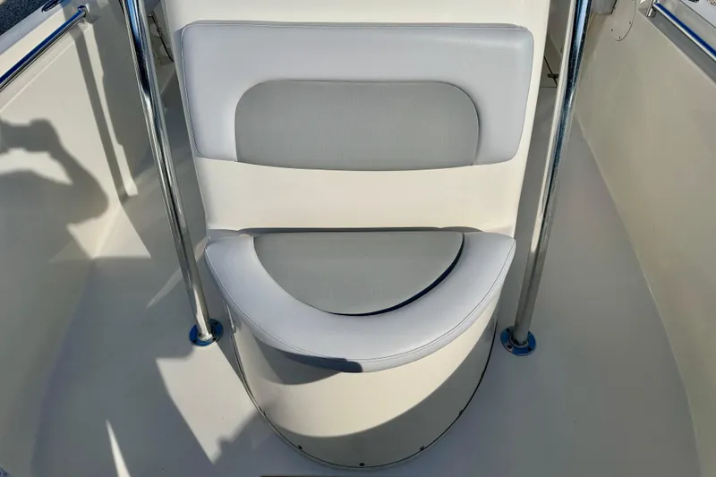 Slide: The Image of 2021 Cobia 237 Center Console boat seat with gray and white cushioned design. - 32